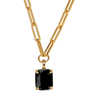 Gold chain necklace with a black pendant on a white background
