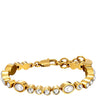 A gold-plated tennis bracelet featuring alternating oval white pearls and round clear rhinestones, displayed on a clean white background.