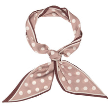 A square silk scarf tied in a knot, featuring a dusty rose pink and white polka dot pattern with a thin dark brown border, set against a solid white background.