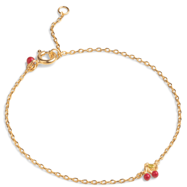 Gold bracelet with red beads on a white background