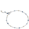 Silver bracelet with blue and beige beads on a white background