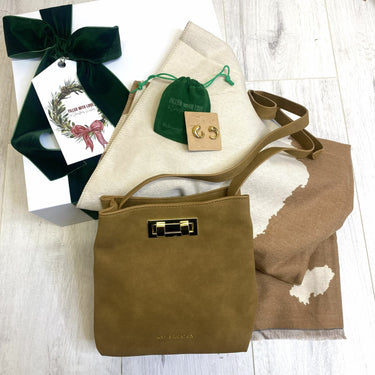 Brown handbag with gold clasp, gift box, and jewelry on a white surface