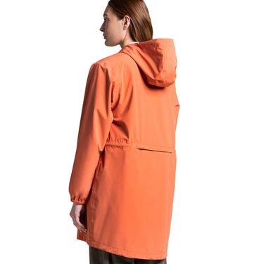 Person wearing an orange raincoat on a white background