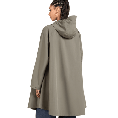 Person wearing a beige raincoat on a white background