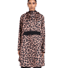 Person wearing a leopard print coat with a black pocket on a white background