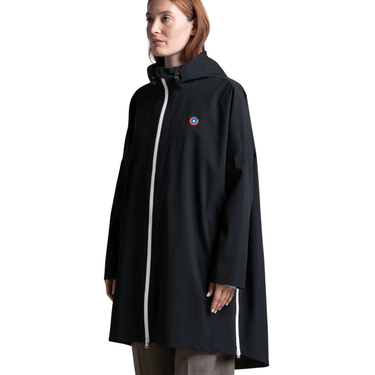 Woman wearing a black raincoat with a brand logo on a white background