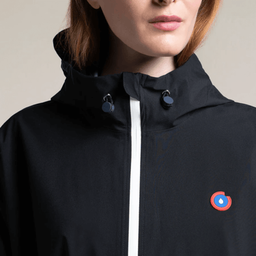 Black jacket with a logo on the chest against a neutral background