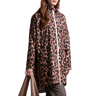 Person wearing a leopard print raincoat with a visible brand logo on a white background