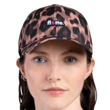 A woman wearing a leopard-print baseball cap with a small 'flo-lette.' logo patch on the front, shown against a plain white background.