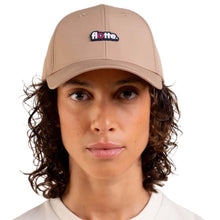 A person wearing a beige baseball cap with a small 'flotte.' embroidered logo on the front, shown against a plain white background.