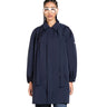 lady wearing a navy blue coat on a white background