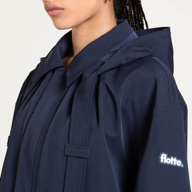 Navy raincoat with 'flotte' logo on a white background