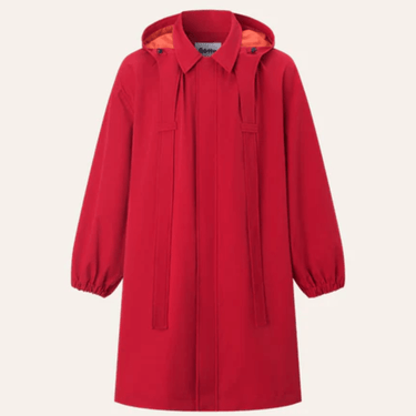 Red raincoat with a hood on a light beige background