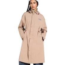 A woman wearing a beige hooded raincoat with a drawstring waist and a small Patagonia logo patch on the chest, set against a plain white background.