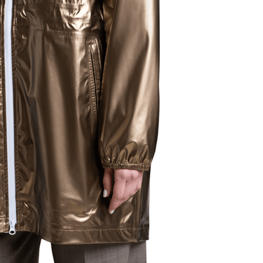 Gold raincoat with a white zipper on a white background
