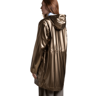Person wearing a shiny gold raincoat on a white background