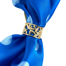 Gold scarf ring on a blue fabric background