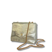 Gold metallic handbag with a chain strap on a white background