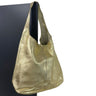 Gold metallic handbag on a black background