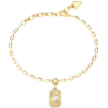 A gold chain bracelet with a rectangular pendant featuring a sunburst design, a small border of clear stones, and a central white heart. The bracelet is displayed on a clean white background.