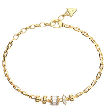 A gold chain bracelet with a lobster clasp, featuring a small triangular charm engraved with 'GRANDE' and a central cluster of clear baguette and round crystals, displayed on a solid white background.