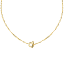Gold necklace with a small pendant on a white background
