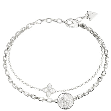 A silver-toned double-strand chain bracelet featuring a circular medallion, a four-petal floral charm, and a triangular logo tag on the clasp, set against a plain white background.