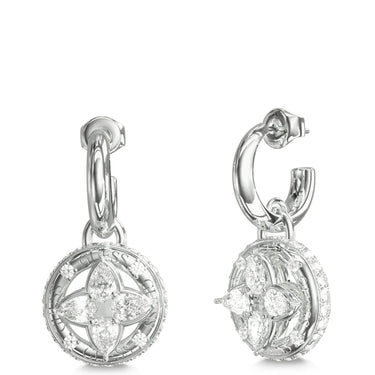 A pair of silver-toned huggie hoop earrings with circular drop charms featuring a floral quatrefoil design set with clear stones, shown from front and side angles on a white background.