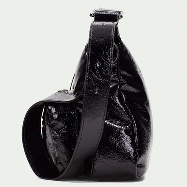 Black leather sling bag on a light gray background