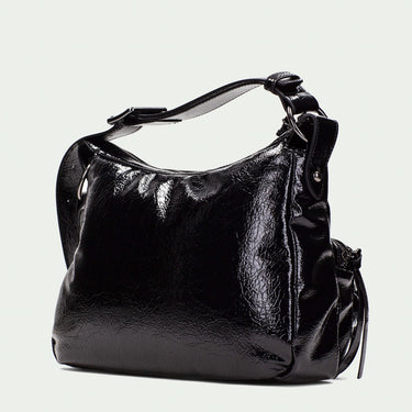 Black handbag on a light beige background