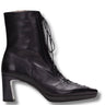 A black leather ankle boot with a block heel, pointed toe, and lace-up front, shown from a side profile on a white background.