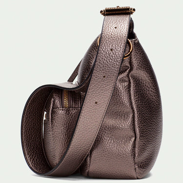 Brown leather sling bag on a light gray background