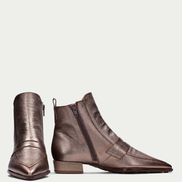 Pair of bronze ankle boots on a light gray background