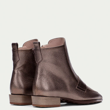 Pair of brown leather ankle boots on a light gray background