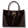 A dark brown handbag with a mix of suede and textured leather panels, featuring dual top handles, a front strap closure with a leather tassel, and a gold-tone metal D-ring and brand plaque.