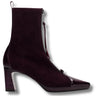 A dark plum purple suede ankle boot with a pointed toe, a chunky block heel, and a side zipper with a tassel pull, shown against a plain white background.