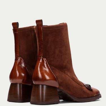 Pair of brown leather ankle boots on a light gray background