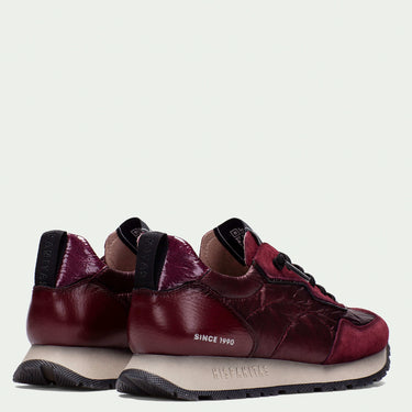 Pair of maroon sneakers with black accents