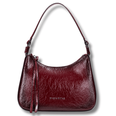 Burgundy handbag with a strap on a white background