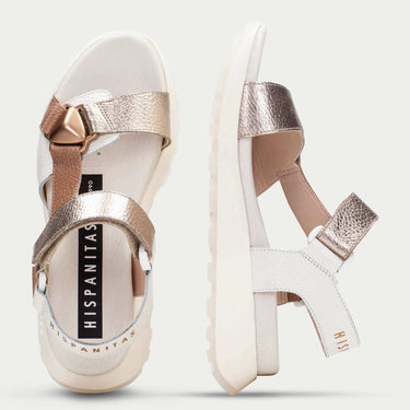 Pair of sandals with metallic straps on a white background
