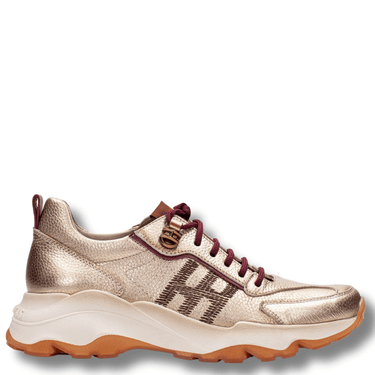 Gold sneaker with brown laces on a white background