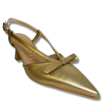 Gold high-heeled shoe with a bow on a white background