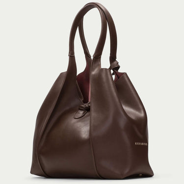 Brown leather handbag on a light gray background