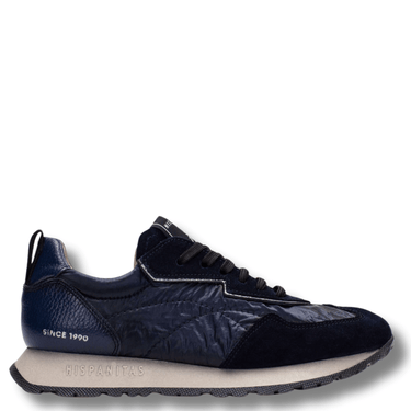 Navy blue sneaker with white sole on a white background