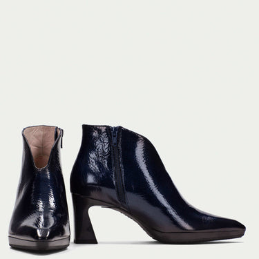 Pair of dark navy ankle boots on a white background