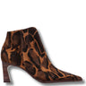 A pointed-toe ankle boot with a brown and black leopard print suede upper and a dark wood-look block heel, shown on a white background with a drop shadow.