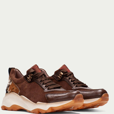 Brown leather sneakers with white soles on a light gray background