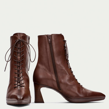 Pair of brown leather boots with lace-up design on a white background