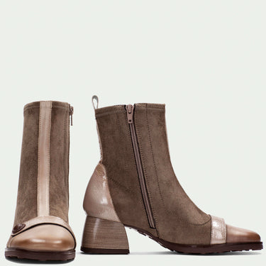 Pair of brown ankle boots with a transparent section on a light gray background