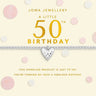 Joma Jewellery 50th birthday bracelet with heart charm on a polka dot background